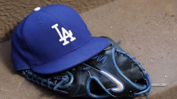 Aug 12, 2014; Atlanta, GA, USA; Detailed view of Los Angeles Dodgers hat and glove in the dugout against the Atlanta Braves in the third inning at Turner Field. Mandatory Credit: Brett Davis-USA TODAY Sports