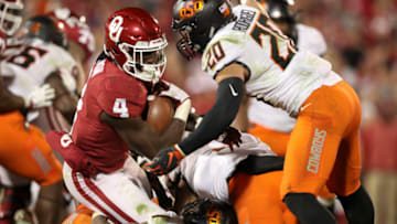 Nov 10, 2018; Norman, OK, USA; Oklahoma Sooners running back Trey Sermon (4) scores a touchdown during the second half against the Oklahoma State Cowboys at Gaylord Family - Oklahoma Memorial Stadium. Mandatory Credit: Kevin Jairaj-USA TODAY Sports