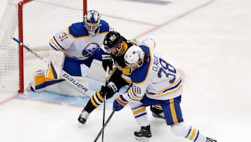 Oct 7, 2022; Pittsburgh, Pennsylvania, USA; Buffalo Sabres goaltender Eric Comrie (31) and defenseman Kale Clague (38) defend Pittsburgh Penguins left wing Jason Zucker (16) during the second period at PPG Paints Arena. Mandatory Credit: Charles LeClaire-USA TODAY Sports