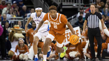 Mar 11, 2023; Kansas City, MO, USA; Texas Longhorns guard Arterio Morris (2) handles the ball while being chased by Kansas Jayhawks guard Dajuan Harris Jr. (3) in the first half at T-Mobile Center. Mandatory Credit: Amy Kontras-USA TODAY Sports