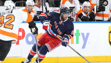 NEW YORK, NY - NOVEMBER 29: Anthony Duclair #63 of the New York Rangers skates with the puck against Mark Streit #32 of the Philadelphia Flyers at Madison Square Garden on November 29, 2014 in New York City. The New York Rangers won 5-2. (Photo by Jared Silber/NHLI via Getty Images)