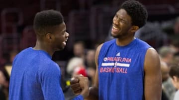 Mar 7, 2015; Philadelphia, PA, USA; Philadelphia 76ers center Nerlens Noel (left) and center Joel Embiid (right) share a laugh during warm ups before a game against the Atlanta Hawks at Wells Fargo Center. Mandatory Credit: Bill Streicher-USA TODAY Sports