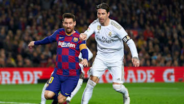 Lionel Messi of Barcelona is tackled by Sergio Ramos of Real Madrid. (Photo by Quality Sport Images/Getty Images)