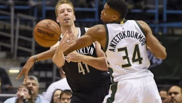Oct 29, 2016; Milwaukee, WI, USA; Brooklyn Nets center Justin Hamilton (41) passes the ball around Milwaukee Bucks forward Giannis Antetokounmpo (34) in the second quarter at BMO Harris Bradley Center. Mandatory Credit: Benny Sieu-USA TODAY Sports
