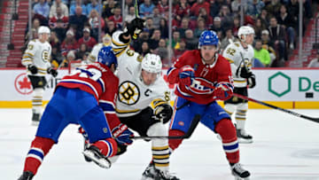 Nov 11, 2023; Montreal, Quebec, CAN; Boston Bruins forward Brad Marchand (63) splits Montreal Canadiens defenseman Justin Barron (52) and teammate forward Alex Newhook (15) during the first period at the Bell Centre. Mandatory Credit: Eric Bolte-USA TODAY Sports