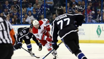 Mar 5, 2016; Tampa, FL, USA; Carolina Hurricanes center Derek Ryan (33) skates with the puck as Tampa Bay Lightning left wing Ondrej Palat (18) and defenseman Victor Hedman (77) defend during the first period at Amalie Arena. Mandatory Credit: Kim Klement-USA TODAY Sports