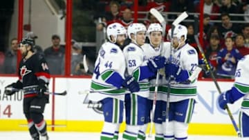 Jan 15, 2016; Raleigh, NC, USA; Vancouver Canucks forward Bo Horvat (53) is congratulated by teammates defensemen Matt Bartkowski (44) forward Jake Virtanen (18) and forward Daniel Sedin (22) after his second period goal against the Carolina Hurricanes at PNC Arena. Mandatory Credit: James Guillory-USA TODAY Sports