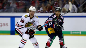 BERLIN, GERMANY - SEPTEMBER 29: Austin Ortega (R) of Eisbaeren Berlin challenges Jonathan Toews of Chicago Blackhawks during the NHL Global Series Challenge 2019 match between Eisbaeren Berlin and Chicago Blackhawks at Mercedes-Benz Arena on September 29, 2019 in Berlin, Germany. (Photo by Martin Rose/NHLI via Getty Images)