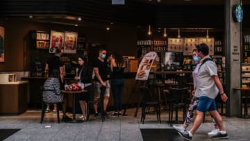 KRAKOW, POLAND - 2021/06/10: People walk past a Starbucks Coffee shop inside a shopping mall. (Photo by Omar Marques/SOPA Images/LightRocket via Getty Images)