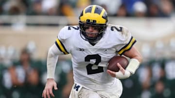EAST LANSING, MI - OCTOBER 20: Shea Patterson #2 of the Michigan Wolverines runs the ball in the second half while playing the Michigan State Spartans at Spartan Stadium on October 20, 2018 in East Lansing, Michigan. Michigan won the game 21-7. (Photo by Gregory Shamus/Getty Images)