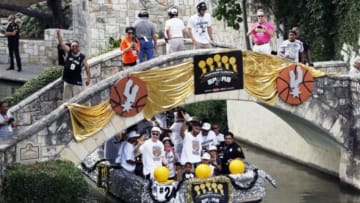 Jun 18, 2014; San Antonio, TX, USA; San Antonio Spurs forward Tim Duncan (front middle) waves to the fans during the NBA championship parade at San Antonio River Walk. Mandatory Credit: Soobum Im-USA TODAY Sports