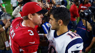 Sep 11, 2016; Glendale, AZ, USA; New England Patriots quarterback Jimmy Garoppolo (10) greets Arizona Cardinals quarterback Carson Palmer following the game at University of Phoenix Stadium. The Patriots defeated the Cardinals 23-21. Mandatory Credit: Mark J. Rebilas-USA TODAY Sports