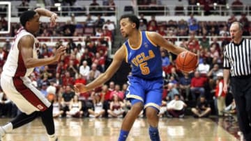 Feb 22, 2014; Stanford, CA, USA; UCLA Bruins guard Kyle Anderson (5) dribbles the ball next to Stanford Cardinal guard Anthony Brown (21) in the second half at Maples Pavilion. The Cardinal defeated the Bruins 83-74. Mandatory Credit: Cary Edmondson-USA TODAY Sports