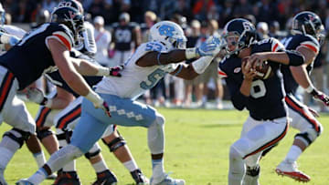 Oct 22, 2016; Charlottesville, VA, USA; Virginia Cavaliers quarterback Kurt Benkert (6) attempts to avoid the tackle of North Carolina Tar Heels defensive end Malik Carney (53) in the second quarter at Scott Stadium. Mandatory Credit: Amber Searls-USA TODAY Sports