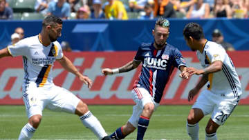 May 8, 2016; Carson, CA, USA; LLos Angeles Galaxy midfielder Sebastian Lletget (17), New England Revolution forward Diego Fagundez (14) and Galaxy defender A. J. DeLaGarza (20) battle for the ball in the first half at StubHub Center. Mandatory Credit: Jayne Kamin-Oncea-USA TODAY Sports
