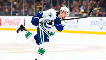 BOSTON, MA - FEBRUARY 04: Quinn Hughes #43 of the Vancouver Canucks shoots the puck during a game against the Boston Bruins at TD Garden on February 4, 2020 in Boston, Massachusetts. (Photo by Adam Glanzman/Getty Images)