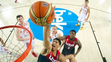 Anthony Davis (14) of Team USA dunks as Omer Asik (14) of Turkey looks on. Now teammates with the New Orleans Pelicans, neither may play Saturday in the team's preseason opener. (FIBA photo)