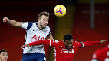 Tottenham Hotspur's English striker Harry Kane (2L) vies to header the ball against Liverpool's Dutch midfielder Georginio Wijnaldum during the English Premier League football match between Liverpool and Tottenham Hotspur at Anfield in Liverpool, north west England on December 16, 2020. (Photo by Clive Brunskill / POOL / AFP) / RESTRICTED TO EDITORIAL USE. No use with unauthorized audio, video, data, fixture lists, club/league logos or 'live' services. Online in-match use limited to 120 images. An additional 40 images may be used in extra time. No video emulation. Social media in-match use limited to 120 images. An additional 40 images may be used in extra time. No use in betting publications, games or single club/league/player publications. / (Photo by CLIVE BRUNSKILL/POOL/AFP via Getty Images)