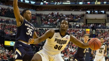 Dec 17, 2016; Indianapolis, IN, USA; Purdue Boilermakers forward Caleb Swanigan (50) dribbles the ball while Notre Dame Fighting Irish forward Bonzie Colson (35) defends in the second half of the game at Bankers Life Fieldhouse. The Purdue Boilermakers beat Notre Dame Fighting Irish 86-81. Mandatory Credit: Trevor Ruszkowski-USA TODAY Sports