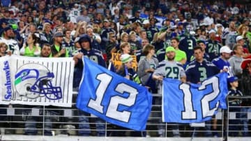 Dec 21, 2014; Glendale, AZ, USA; Seattle Seahawks fans in the grandstands hold 12th man flags against the Arizona Cardinals at University of Phoenix Stadium. The Seahawks defeated the Cardinals 35-6. Mandatory Credit: Mark J. Rebilas-USA TODAY Sports