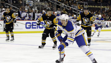 Oct 5, 2021; Pittsburgh, Pennsylvania, USA; Buffalo Sabres right wing John-Jason Peterka (77) carries the puck into the offensive zone against the Pittsburgh Penguins during the third period at PPG Paints Arena. The Penguins won 5-4 in a shootout. Mandatory Credit: Charles LeClaire-USA TODAY Sports