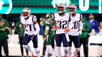 EAST RUTHERFORD, NEW JERSEY - OCTOBER 21: J.C. Jackson #27, Devin McCourty #32 and Jason McCourty #30 of the New England Patriots look on against the New York Jets at MetLife Stadium on October 21, 2019 in East Rutherford, New Jersey. (Photo by Steven Ryan/Getty Images)