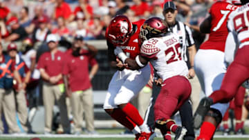 LOUISVILLE, KY - SEPTEMBER 29: DeCalon Brooks #28 of the Florida State Seminoles knocks the ball out of the hands of Jawon Pass #4 of the Louisville Cardinals in the first quarter of the game at Cardinal Stadium on September 29, 2018 in Louisville, Kentucky. (Photo by Joe Robbins/Getty Images)