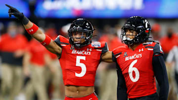 ATLANTA, GEORGIA - JANUARY 01: Safety Darrick Forrest #5 and safety Bryan Cook #6 of the Cincinnati Bearcats celebrate after a defensive play during the Chick-fil-A Peach Bowl against the Georgia Bulldogs at Mercedes-Benz Stadium on January 01, 2021 in Atlanta, Georgia. (Photo by Mike Zarrilli/Getty Images)