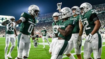 Michigan State's Jayden Reed, center, celebrates with teammates after his punt return for a touchdown against Western Kentucky during the first quarter on Saturday, Oct. 2, 2021, at Spartan Stadium in East Lansing.211002 Msu Wku Fb 062a