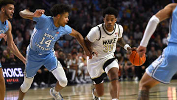 Feb 7, 2023; Winston-Salem, North Carolina, USA; Wake Forest Demon Deacons guard Damari Monsanto (30) drives on North Carolina Tar Heels forward Puff Johnson (14) during the first half at Lawrence Joel Veterans Memorial Coliseum. Mandatory Credit: William Howard-USA TODAY Sports