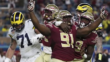 Dec 30, 2016; Miami Gardens, FL, USA; Florida State Seminoles defensive tackle Derrick Nnadi (91) reacts after a sack with defensive end Josh Sweat (9) in the first quarter against the Michigan Wolverines at Hard Rock Stadium. Mandatory Credit: Logan Bowles-USA TODAY Sports