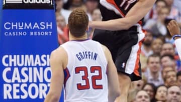 Feb 12, 2014; Los Angeles, CA, USA; Portland Trail Blazers center Meyers Leonard (11) dunks the ball as Los Angeles Clippers forward Blake Griffin (32) defends at Staples Center. The Clippers defeated the Trail Blazers 122-117. Mandatory Credit: Kirby Lee-USA TODAY Sports