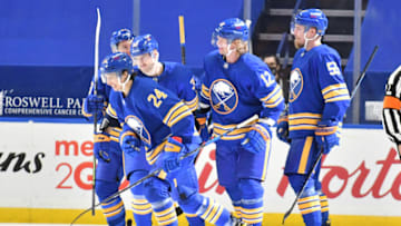 Jan 26, 2021; Buffalo, New York, USA; Buffalo Sabres center Dylan Cozens (24) is congratulated by teammates after scoring a goal against the New York Rangers in the first period of a game at KeyBank Center. Mandatory Credit: Mark Konezny-USA TODAY Sports