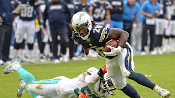 Dec 20, 2015; San Diego, CA, USA; San Diego Chargers running back Melvin Gordon (28) is defended by Miami Dolphins middle linebacker Kelvin Sheppard (52) on a second quarter run at Qualcomm Stadium. Mandatory Credit: Jake Roth-USA TODAY Sports
