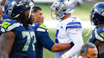 Sep 27, 2020; Seattle, Washington, USA; Seattle Seahawks quarterback Russell Wilson (3, second from right) greets Dallas Cowboys quarterback Dak Prescott (4) following a 38-31 Seattle victory at CenturyLink Field. Mandatory Credit: Joe Nicholson-USA TODAY Sports