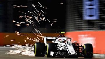 SINGAPORE - SEPTEMBER 14: Sparks fly behind Charles Leclerc of Monaco driving the (16) Alfa Romeo Sauber F1 Team C37 Ferrari on track during practice for the Formula One Grand Prix of Singapore at Marina Bay Street Circuit on September 14, 2018 in Singapore. (Photo by Clive Mason/Getty Images)