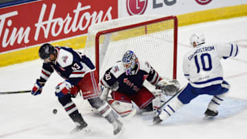 TORONTO, ON - OCTOBER 20: Carl Grundstrom #10 of the Toronto Marlies battles for the puck with Libor Hajek #43 and Alexander Georgiev #30 of the Hartford Wolf Pack during AHL game action on October 20, 2018 at Coca-Cola Coliseum in Toronto, Ontario, Canada. (Photo by Graig Abel/Getty Images)