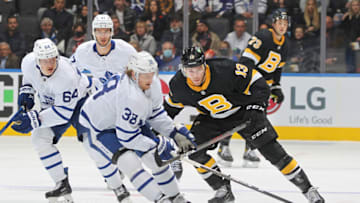 TORONTO, ON - NOVEMBER 6: Charlie Coyle #13 of the Boston Bruins battles for the puck against Rasmus Sandin #38 of the Toronto Maple Leafs during an NHL game at Scotiabank Arena on November 6, 2021 in Toronto, Ontario, Canada. The Maple Leafs defeated the Bruins 5-2. (Photo by Claus Andersen/Getty Images)