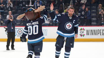WINNIPEG, MB - JANUARY 30: Blake Wheeler #26 of the Winnipeg Jets high fives mascot Mick E. Moose after receiving first star honours following a 3-1 victory over the Tampa Bay Lightning at the Bell MTS Place on January 30, 2018 in Winnipeg, Manitoba, Canada. (Photo by Jonathan Kozub/NHLI via Getty Images)