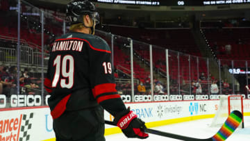 Carolina Hurricanes defenseman Dougie Hamilton (19) has his stick taped for Pride Night against the Tampa Bay Lightning at PNC Arena. Mandatory Credit: James Guillory-USA TODAY Sports