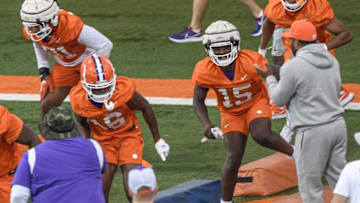 Clemson linebacker Kobe McCloud (31), cornerback Myles Oliver (16), left, defensive end Jahiem Lawson (15) runs by Clemson special teams coordinator Mike Reed during the first day of fall football practice at the Allen Reeves Complex in Clemson Friday, August 5, 2022.Clemson Football First Day Fall Practice