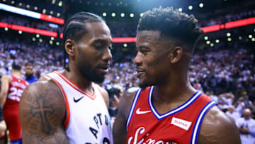 TORONTO, ON - MAY 12: Kawhi Leonard #2 of the Toronto Raptors speaks with Jimmy Butler #23 of the Philadelphia 76ers after sinking a buzzer beater to win Game Seven of the second round of the 2019 NBA Playoffs at Scotiabank Arena on May 12, 2019 in Toronto, Canada. NOTE TO USER: User expressly acknowledges and agrees that, by downloading and or using this photograph, User is consenting to the terms and conditions of the Getty Images License Agreement. (Photo by Vaughn Ridley/Getty Images)