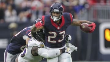 Dec 21, 2014; Houston, TX, USA; Houston Texans running back Arian Foster (23) rushes during the second quarter as Baltimore Ravens outside linebacker Terrell Suggs (55) attempts to make a tackle at NRG Stadium. Mandatory Credit: Troy Taormina-USA TODAY Sports