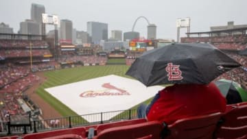 May 30, 2015; St. Louis, MO, USA; A fan sits in the rain during a delay in the game between the St. Louis Cardinals and the Los Angeles Dodgers at Busch Stadium. Mandatory Credit: Jasen Vinlove-USA TODAY Sports