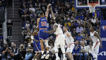 SAN FRANCISCO, CALIFORNIA - OCTOBER 21: Stephen Curry #30 of the Golden State Warriors shoots over Terance Mann #14 of the LA Clippers during the third quarter at Chase Center on October 21, 2021 in San Francisco, California. NOTE TO USER: User expressly acknowledges and agrees that, by downloading and/or using this photograph, User is consenting to the terms and conditions of the Getty Images License Agreement. (Photo by Thearon W. Henderson/Getty Images)