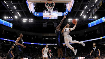 MILWAUKEE, WISCONSIN - DECEMBER 21: Markus Howard #0 of the Marquette Golden Eagles attempts a shot while being guarded by Nick Perkins #33 of the Buffalo Bulls in the second half at the Fiserv Forum on December 21, 2018 in Milwaukee, Wisconsin. (Photo by Dylan Buell/Getty Images)