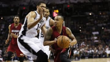 Oct 18, 2014; San Antonio, TX, USA; Miami Heat point guard Shabazz Napier (13) drives to the basket as San Antonio Spurs power forward Jeff Ayres (11) defends during the second half at AT&T Center. The Heat won 111-108 in overtime. Mandatory Credit: Soobum Im-USA TODAY Sports