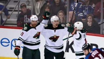 Apr 30, 2014; Denver, CO, USA; Minnesota Wild right wing Nino Niederreiter (22) is congratulated following his game winning overtime period goal by center Kyle Brodziak (21) and left wing Dany Heatley (15) against the Colorado Avalanche in game seven of the first round of the 2014 Stanley Cup Playoffs at Pepsi Center. Mandatory Credit: Ron Chenoy-USA TODAY Sports