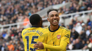 NEWCASTLE UPON TYNE, ENGLAND - AUGUST 11: Pierre-Emerick Aubameyang of Arsenal celebrates with teammate Ainsley Maitland-Niles after scoring his team's first goal during the Premier League match between Newcastle United and Arsenal FC at St. James Park on August 11, 2019 in Newcastle upon Tyne, United Kingdom. (Photo by Stu Forster/Getty Images)