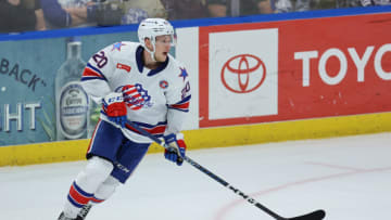 SYRACUSE, NY - APRIL 21: Lawrence Pilut #20 of Rochester Americans moves the puck during the first period against the Syracuse Crunch at Upstate Medical University Arena on April 21, 2023 in Syracuse, New York. (Photo by Isaiah Vazquez/Getty Images)